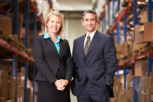 Businesswoman And Businessman In Distribution Warehouse