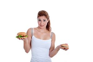 Woman comparing good burger and bad burger to demonstrate promises made and kept
